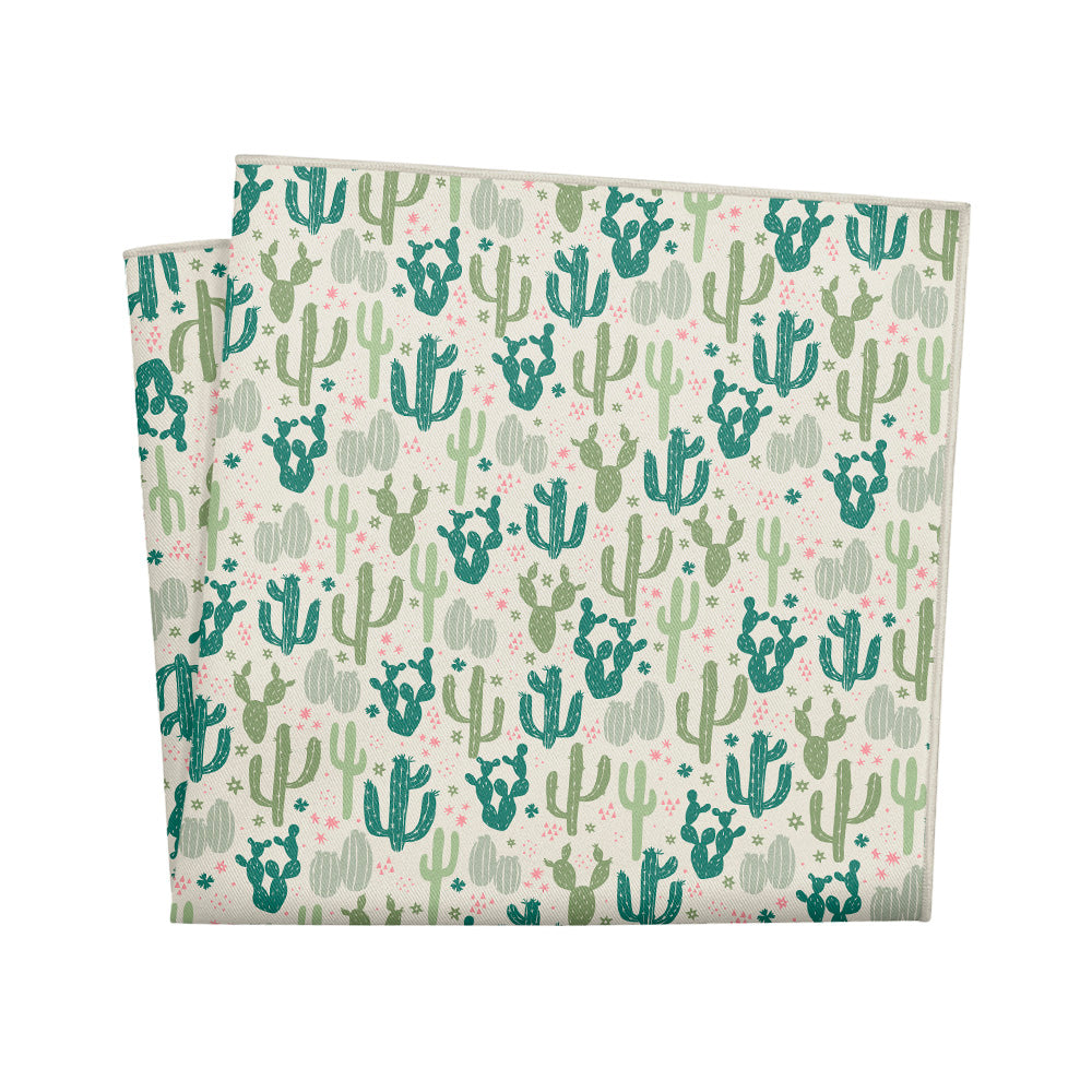 Folded fabric pocket square with cactus pattern on a white background