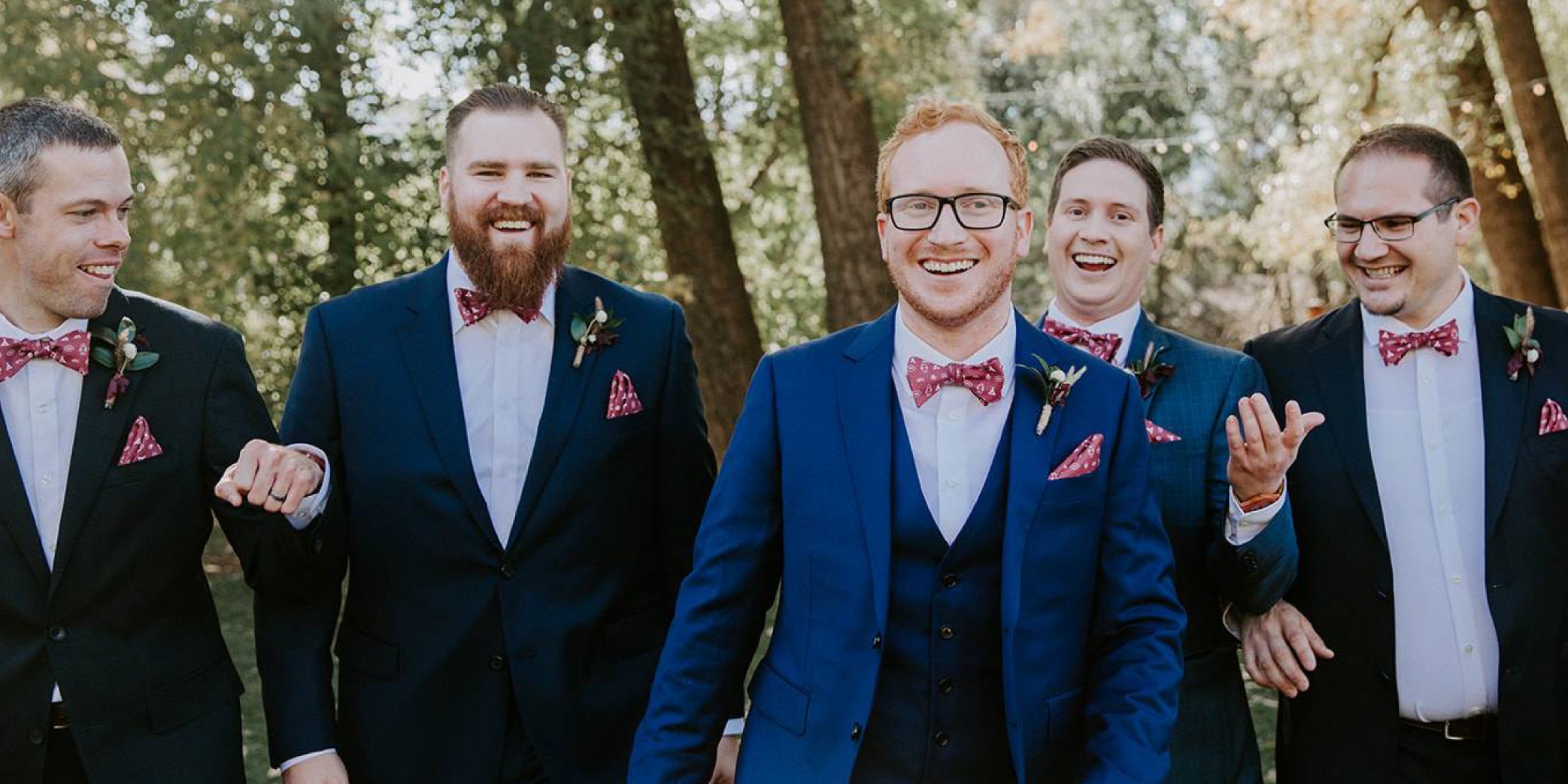 Custom bow ties and pocket squares worn by bridal party
