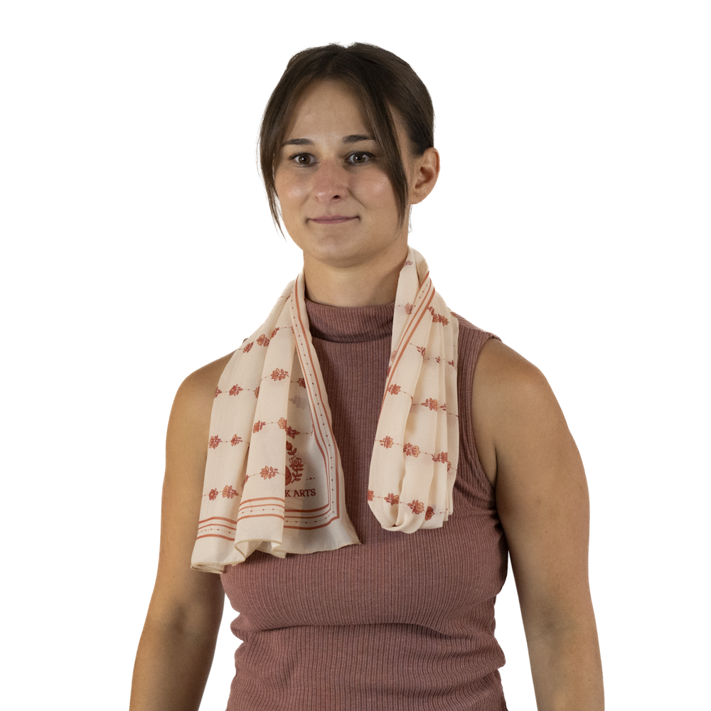 A woman with a half folded rectangle scarf draped around her neck