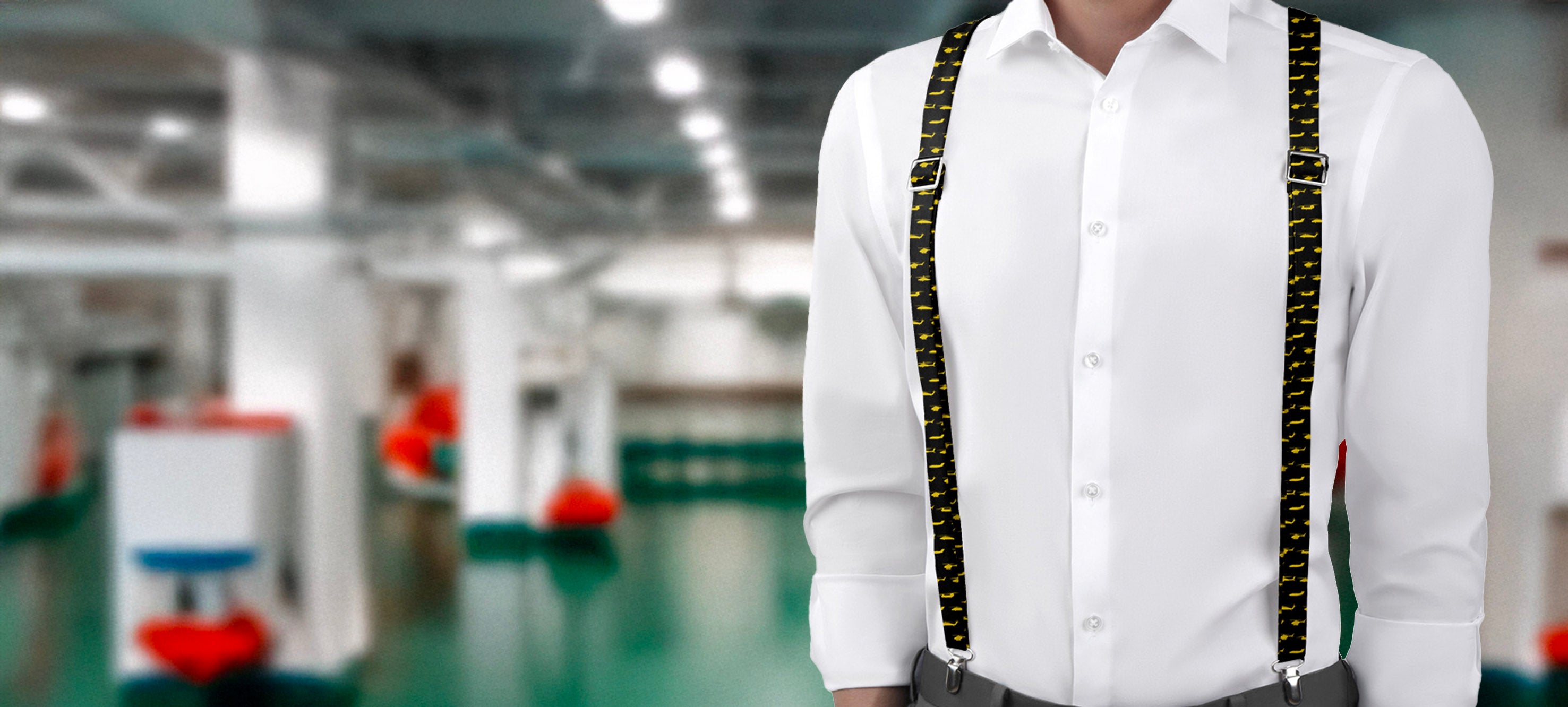 Person wearing a white shirt with military themed suspenders in an industrial setting
