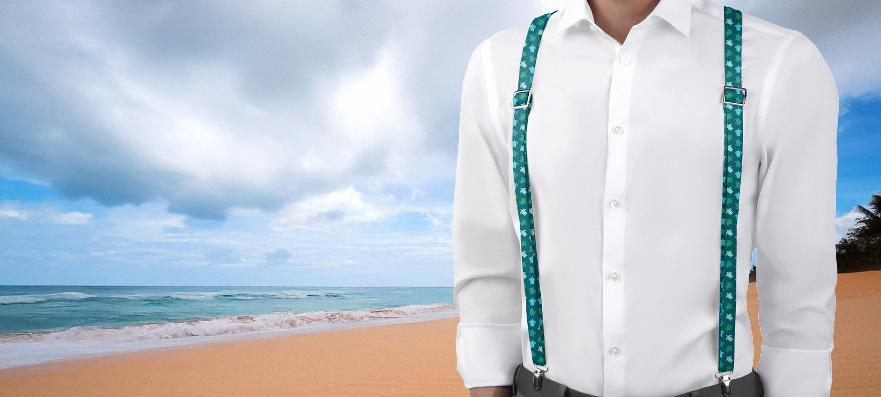 Person wearing a white shirt and green nautical sea turtle suspenders standing on a beach with ocean and sky in the background