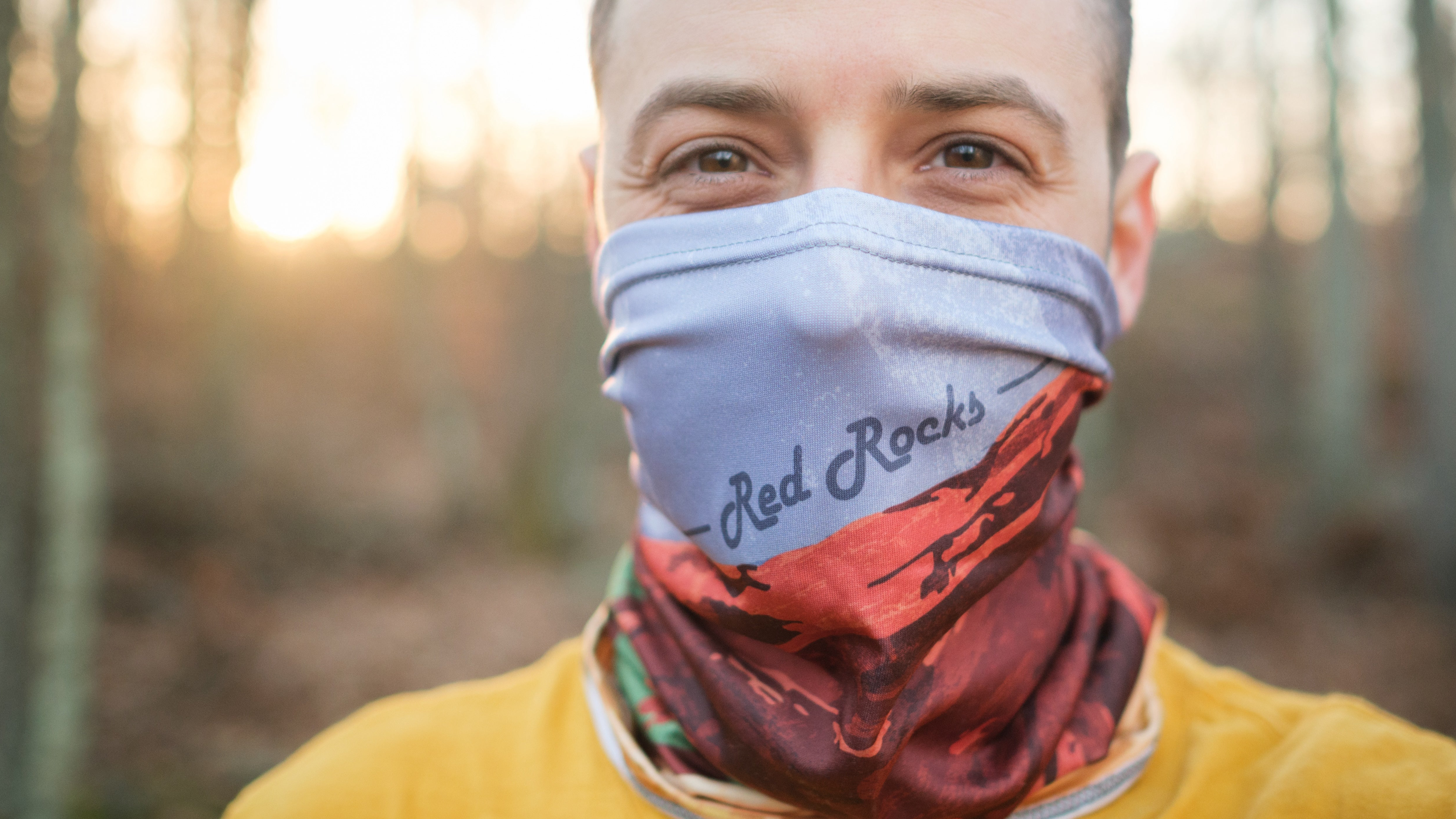 man wearing neck gaiter in outdoor setting