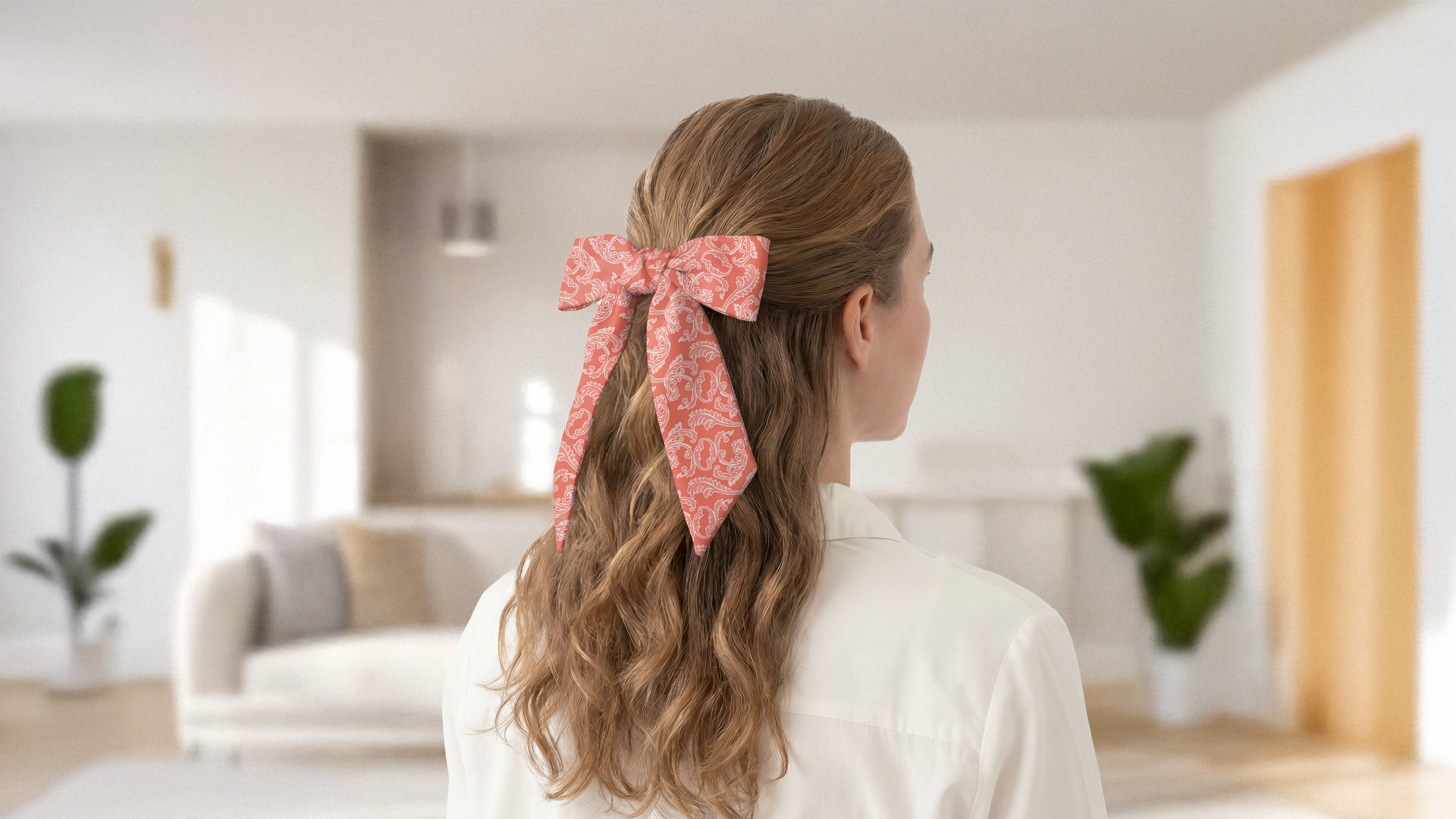 Person with a paisley hair scarf bow in a modern living room