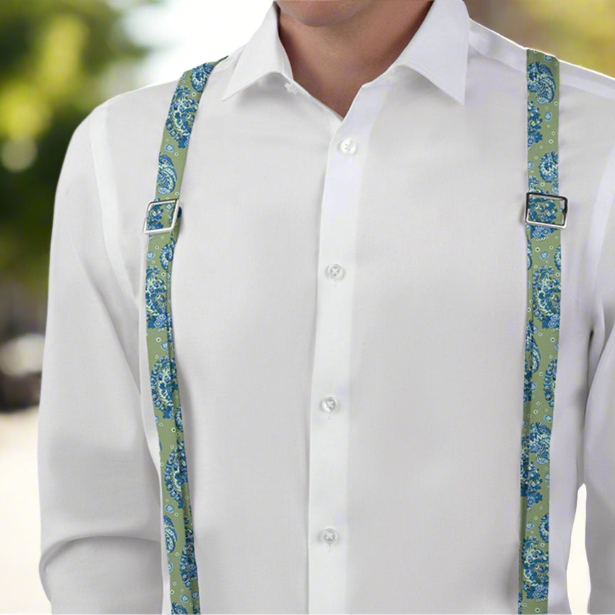 man wearing green and blue paisley suspenders over a white shirt