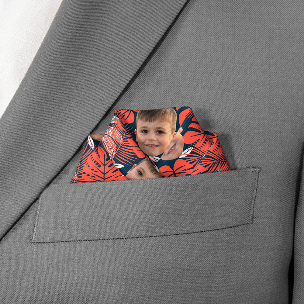 Pocket of a gray suit jacket with a colorful photo pocket square featuring a child's photo.