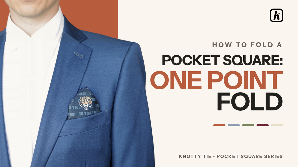 Load video: The one-point fold is a sophisticated and easy-to-master pocket square technique that works well for casual or semiformal events. It creates a subtle peak and is a practical choice for folding for multiple people.To achieve this look, follow these steps:Preparation: Lay the pocket square flat in a diamond shape with one point facing you and the printed side down. If the square features a specific logo, image, or text you wish to display, ensure that detail is positioned at the top point.Initial Fold: Bring the bottom point up to meet the top point to create a triangle and smooth out any wrinkles.Side Folds: Fold the left corner approximately 3/4 of the way toward the right corner, then fold the right corner back over the left. Tuck away any excess fabric.Final Adjustments: Fold the bottom edge upward to shorten the square and flip it over.Placement: Slide the pocket square into your breast pocket with the point facing up, allowing it to peek out a few inches. Adjust the height and angle to achieve a sharp appearance.