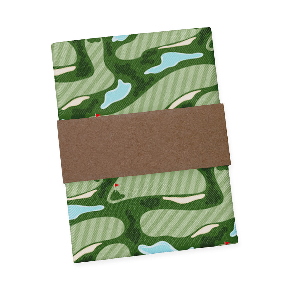 pocket square with green golf course pattern and brown packaging band on a white background