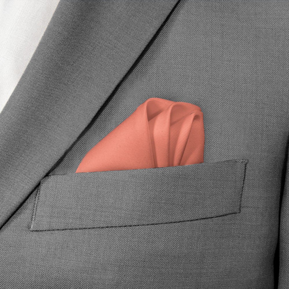 orange pocket square in grey suit jacket pocket