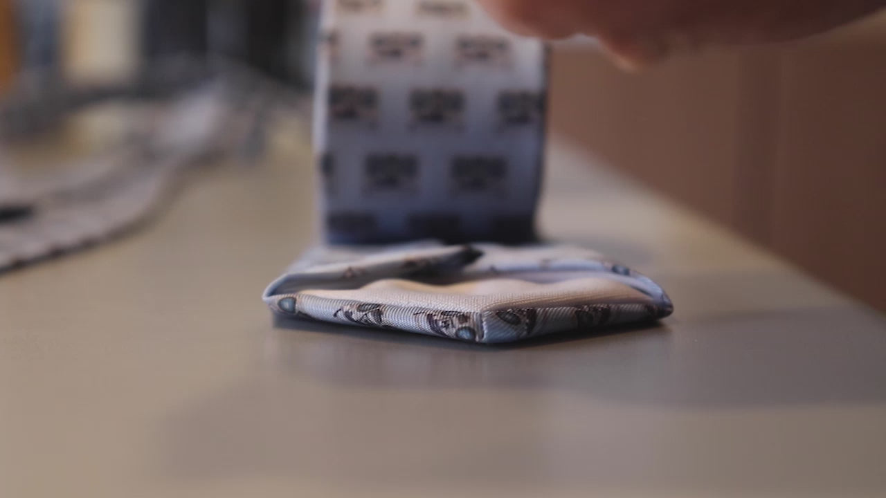 Load video: person rolling a necktie