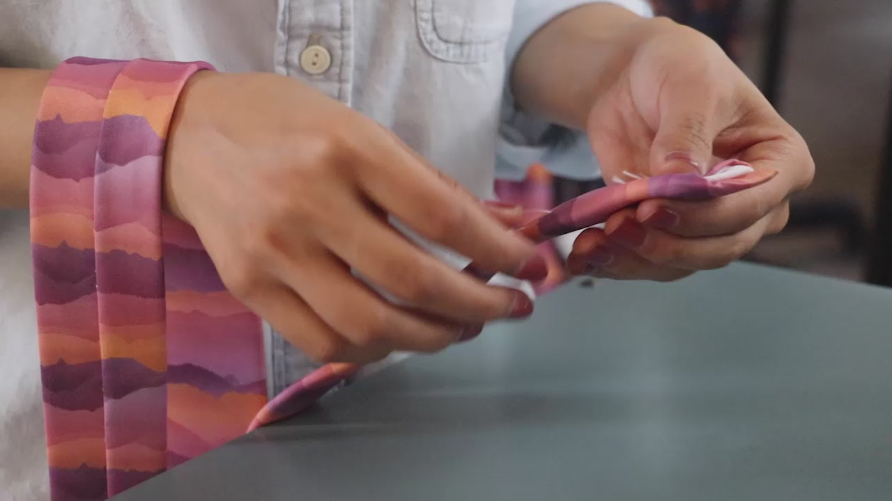 Load video: Woman manufacturing neckties