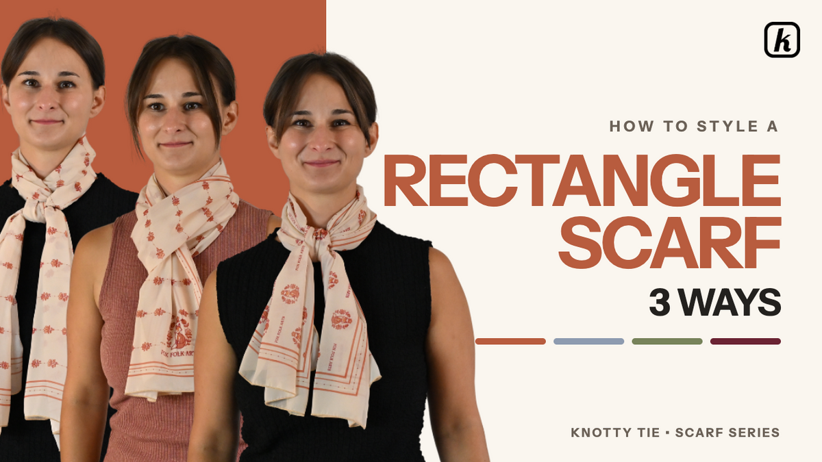 Load video: Rectangle scarves provide an elegant way to add texture and dimension to an outfit. The video outlines three styling methods ranging from beginner to advanced:The European Loop (Beginner): This quick method works with any scarf size.Fold or bunch the scarf lengthwise, then fold it in half to bring the ends together.Drape the scarf behind the neck with the loop on one side and the tails on the other.Pull the tails through the loop and tighten to the desired comfort level.The Threaded Knot (Intermediate): This style works with any size.Bunch the scarf into a narrow band and tie a loose knot in the middle.Place the knot at the front, wrap the tails around the back of the neck, and bring them forward.Thread the right tail through the left side of the knot and the left tail through the right side.The scarf can be worn centered or shifted to the side.The Fitted Twist (Advanced): This method works best with a large scarf.Place the middle of the bunched scarf at the front of the neck, wrap the tails around the back, and bring them to the front.Tie a half-knot snug against the wrap, then slip the top tail behind the wrap and pull it down underneath to create the twist.Optionally, add another half-knot below the twist for extra dimension.