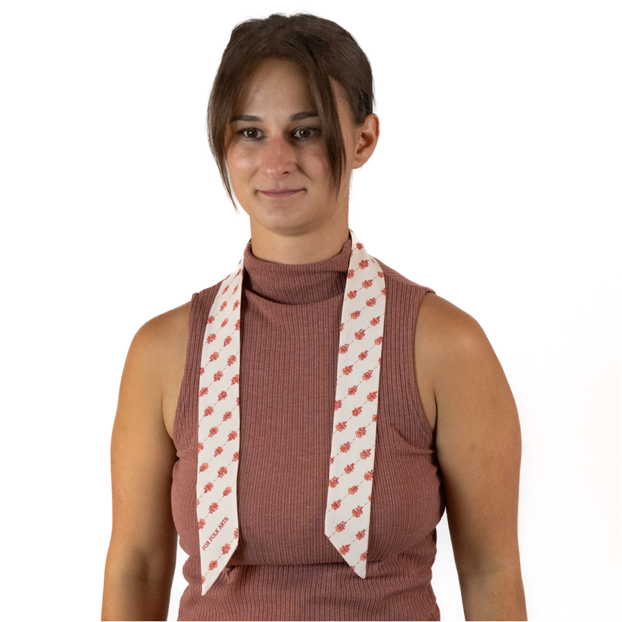 A woman wearing a cream scarf around neck, against a solid white background.
