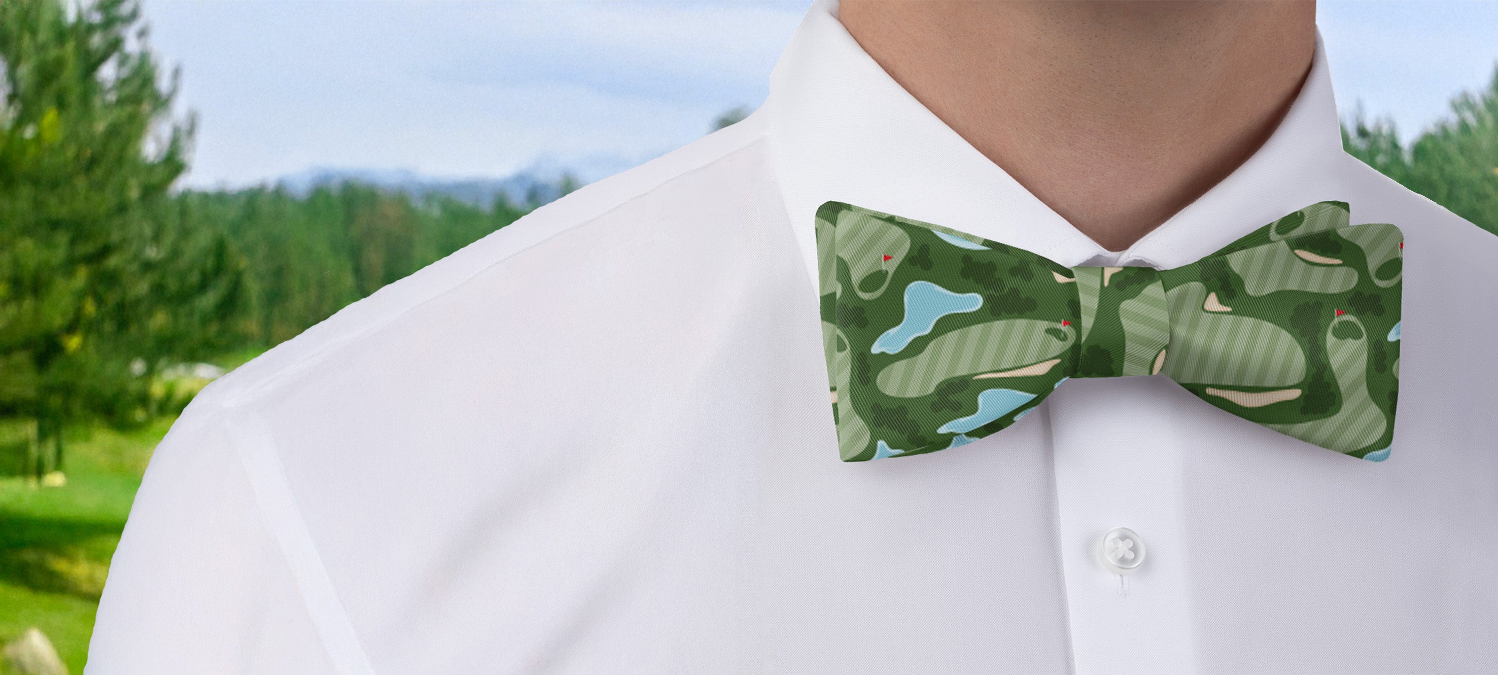 Green golf course bow tie worn by a person with a blurred natural background