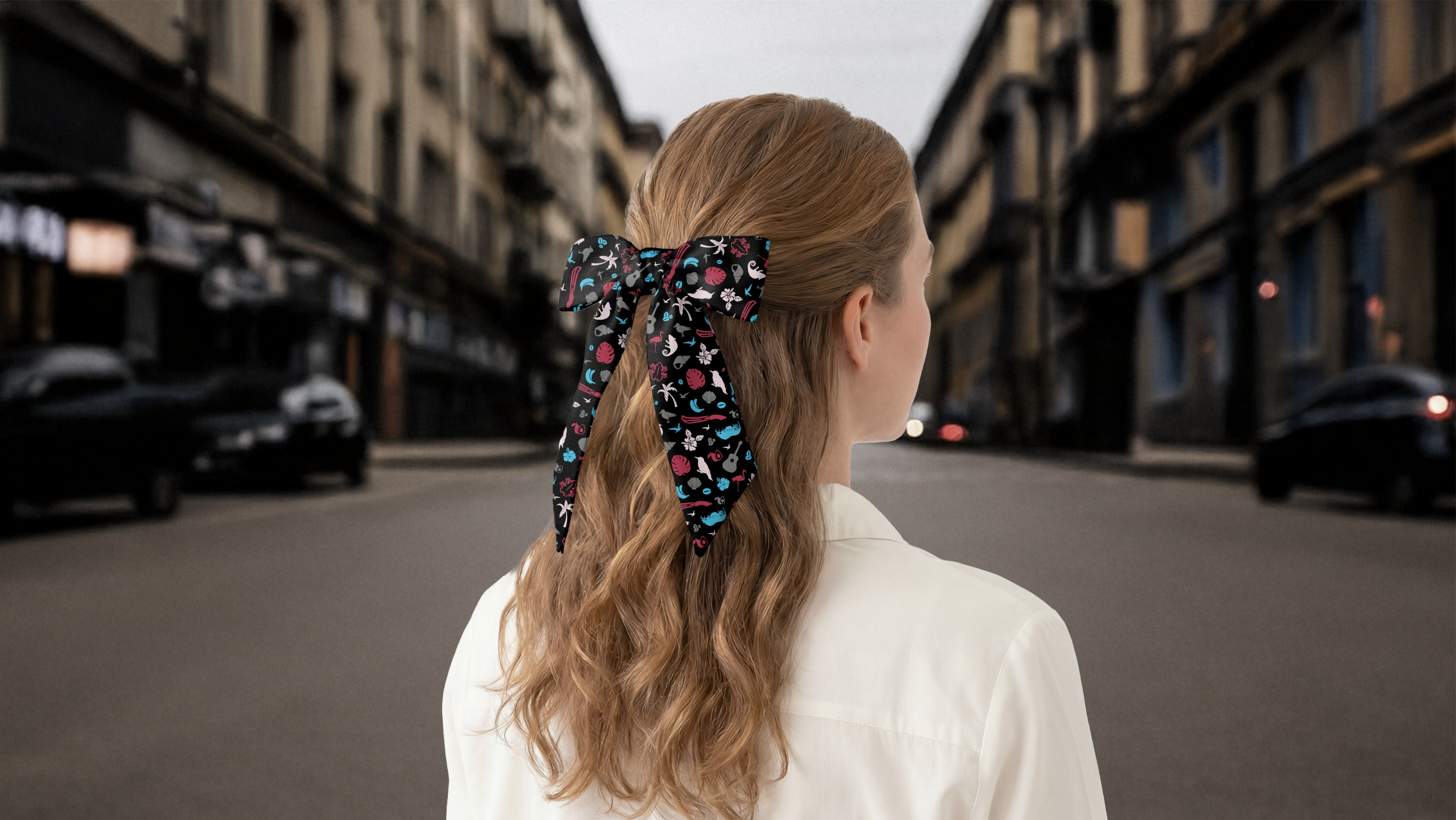 Person with a colorful hair scarf in a city street