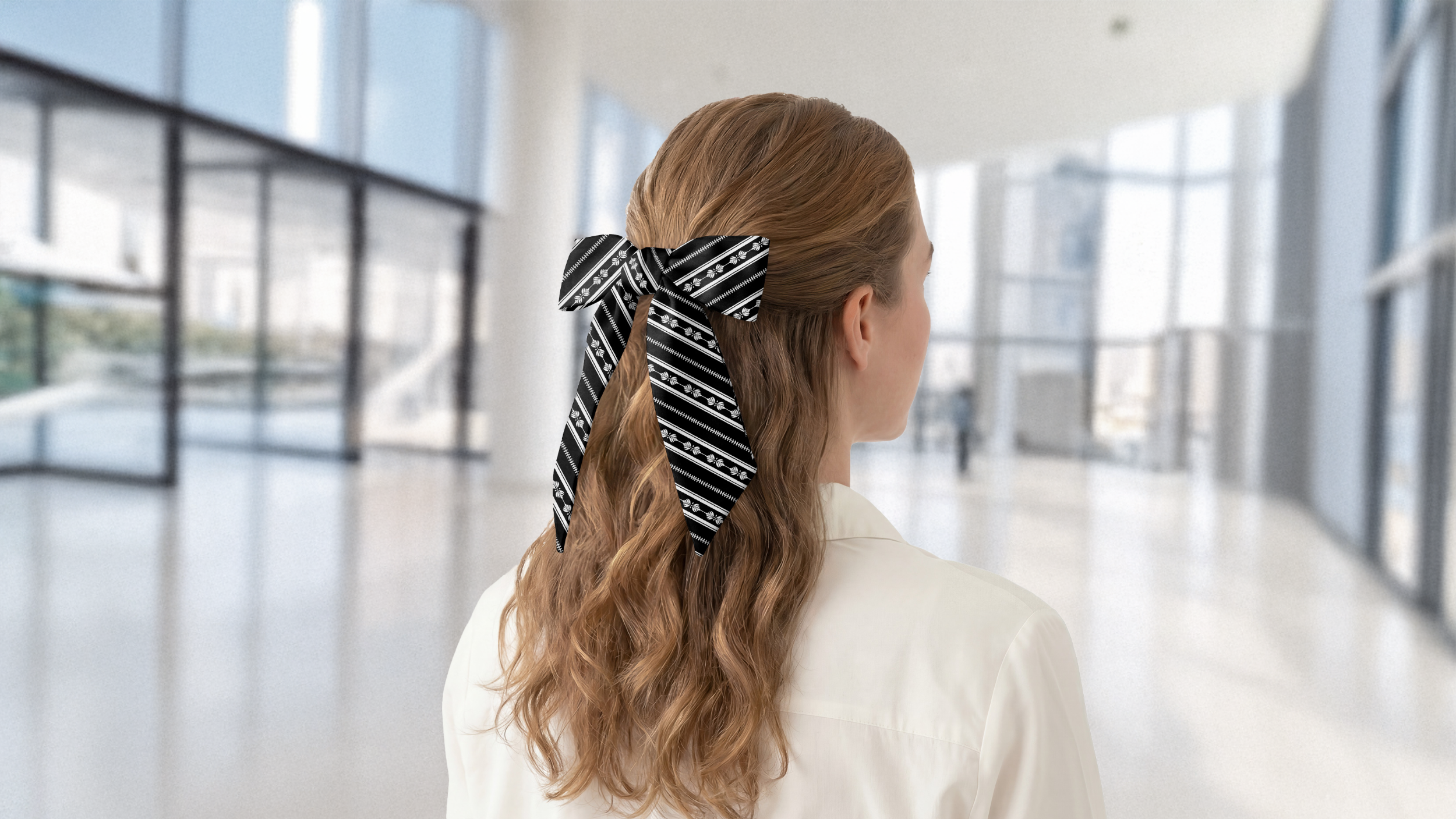 Person with a black and white striped hair scarf in an indoor setting
