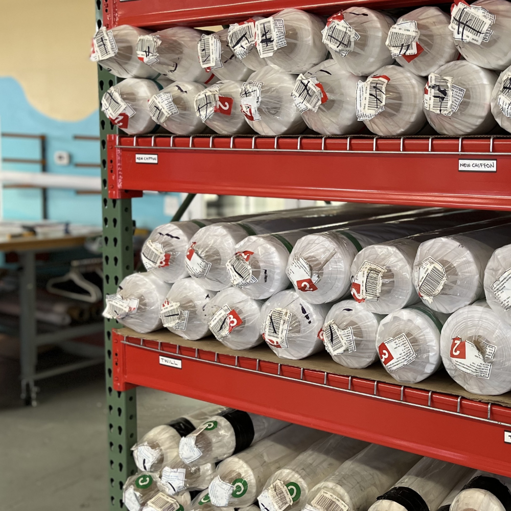 Shelving unit with rolls of paper or fabric in a warehouse setting