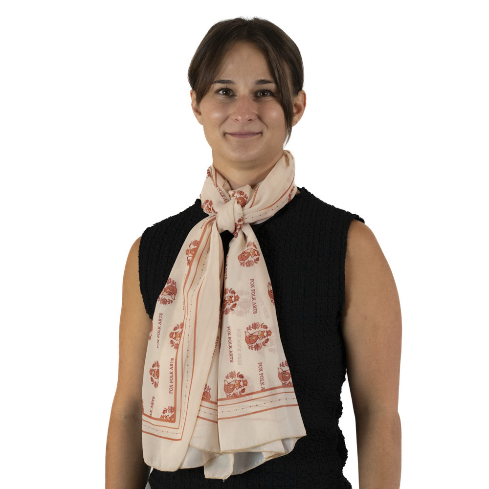 A woman a cream rectangle scarf tied into a threaded knot style