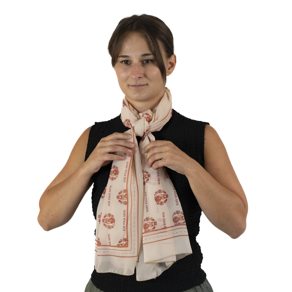 A woman adjusting a threaded knot rectangle scarf style