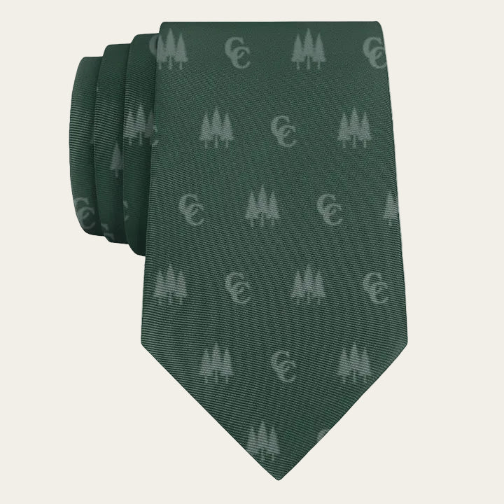 dark green tie with light green tree icons and MM monogram