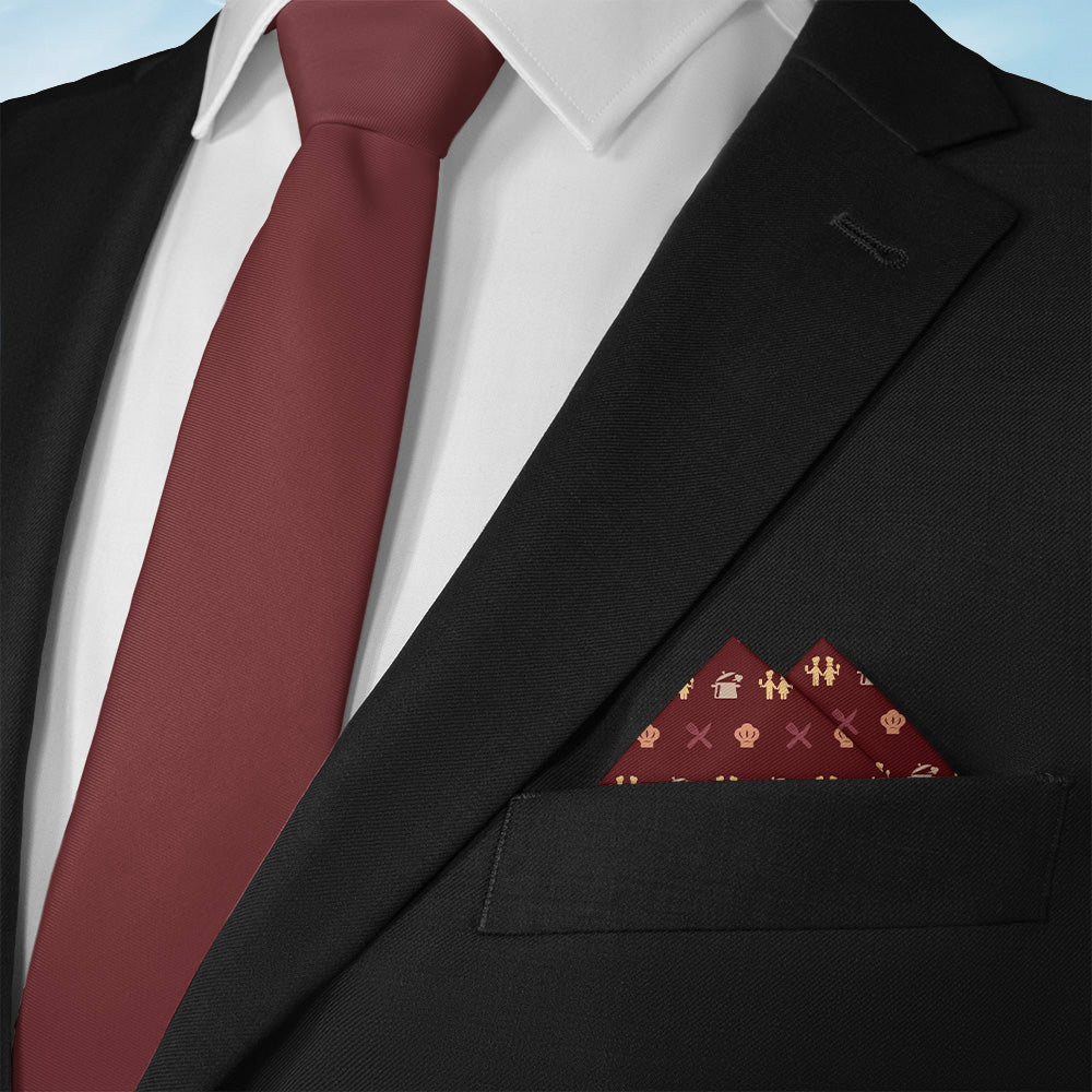 Black suit with a red tie and matching friendship themed pocket square on a light blue background